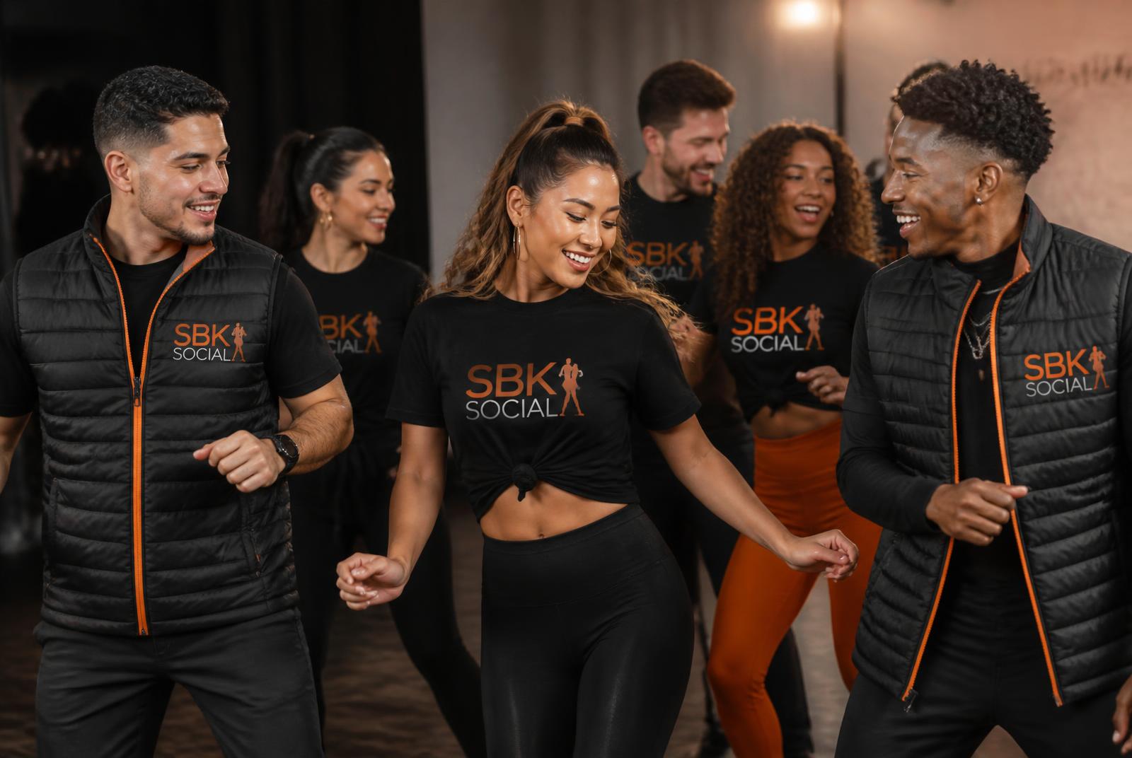 Dancers wearing matching branded club t-shirts and gilets in a studio